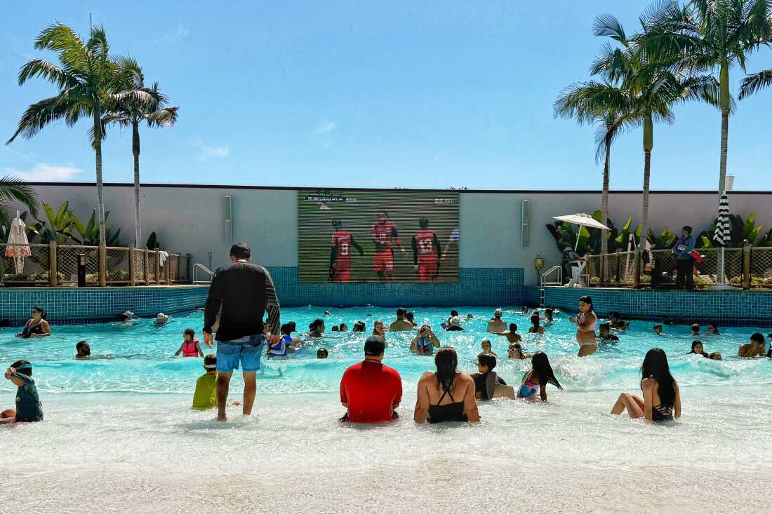 Guests at the Gaylord Pacific Resort and Convention Center wave pool watch Norway play against Senegal on June 22 in Chula Vista, Calif. The resort was filled with young families for Father’s Day, hoping to beat the heat wave, and as soon as the game came on people began to gather around the screen.