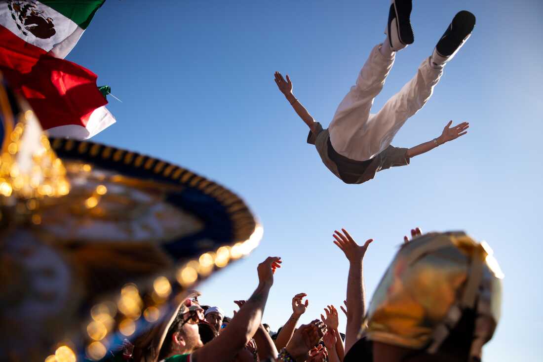 Soccer fans rooting for Mexico are launched into the air in celebration ahead of the FIFA World Cup knockout-round match against England on Sunday, July 5, along the waterfront in Seattle.