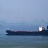 A tugboat guides a ship at the Khor Fakkan Container Terminal, the only natural deep-sea port in the region and one of the major container ports in Sharjah Emirate, along the Gulf of Oman, on July 14.