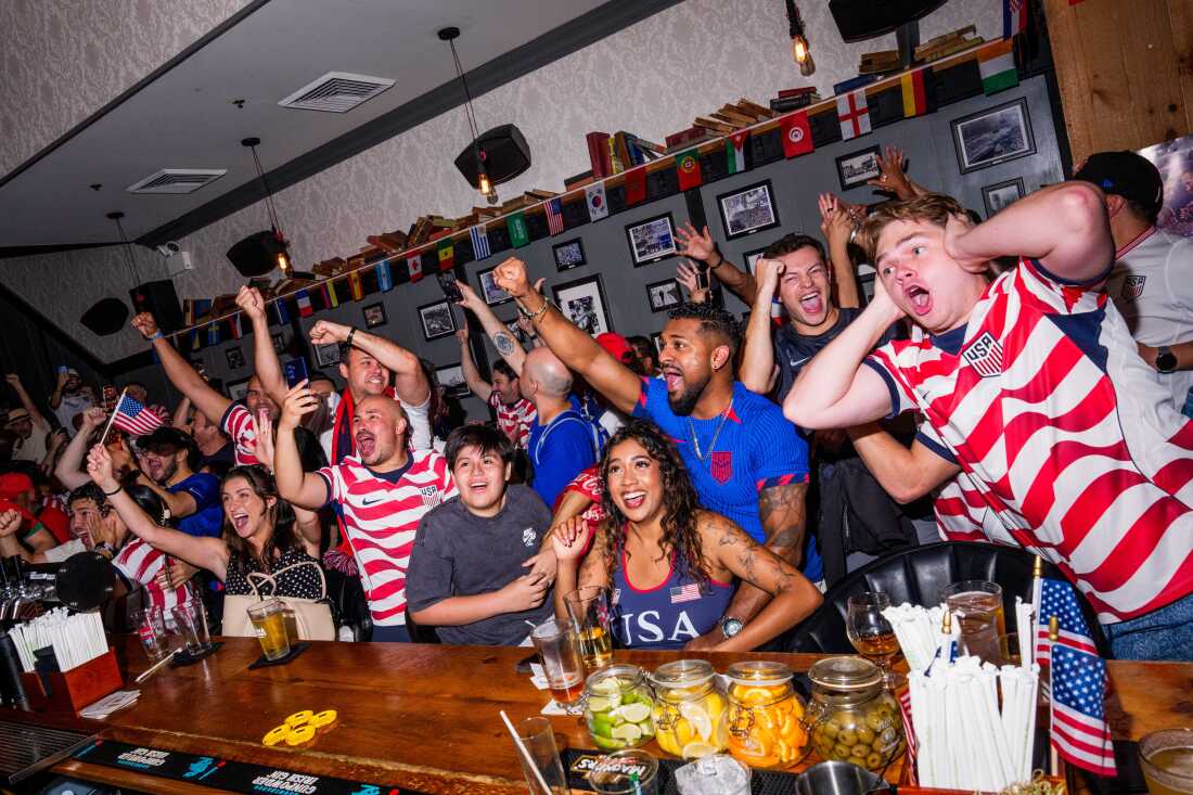 Fans react at a bar in New York as the USA scores to make it 4-1 against Paraguay in a World Cup group match.