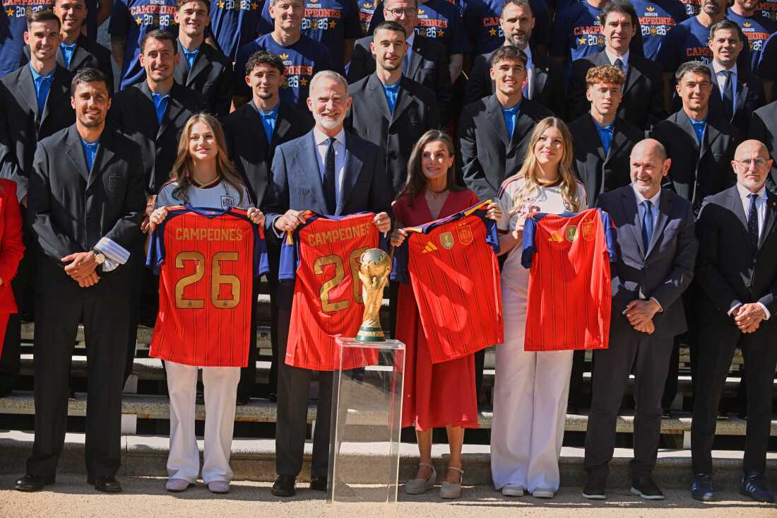 Spain's King Felipe VI and Queen Letizia, accompanied by Princess Leonor, left, and Infanta Sofia, right, pose with players from Spain's national soccer team at Zarzuela Palace in Madrid on Monday, July 20, 2026, after the team was crowned World Cup champion.