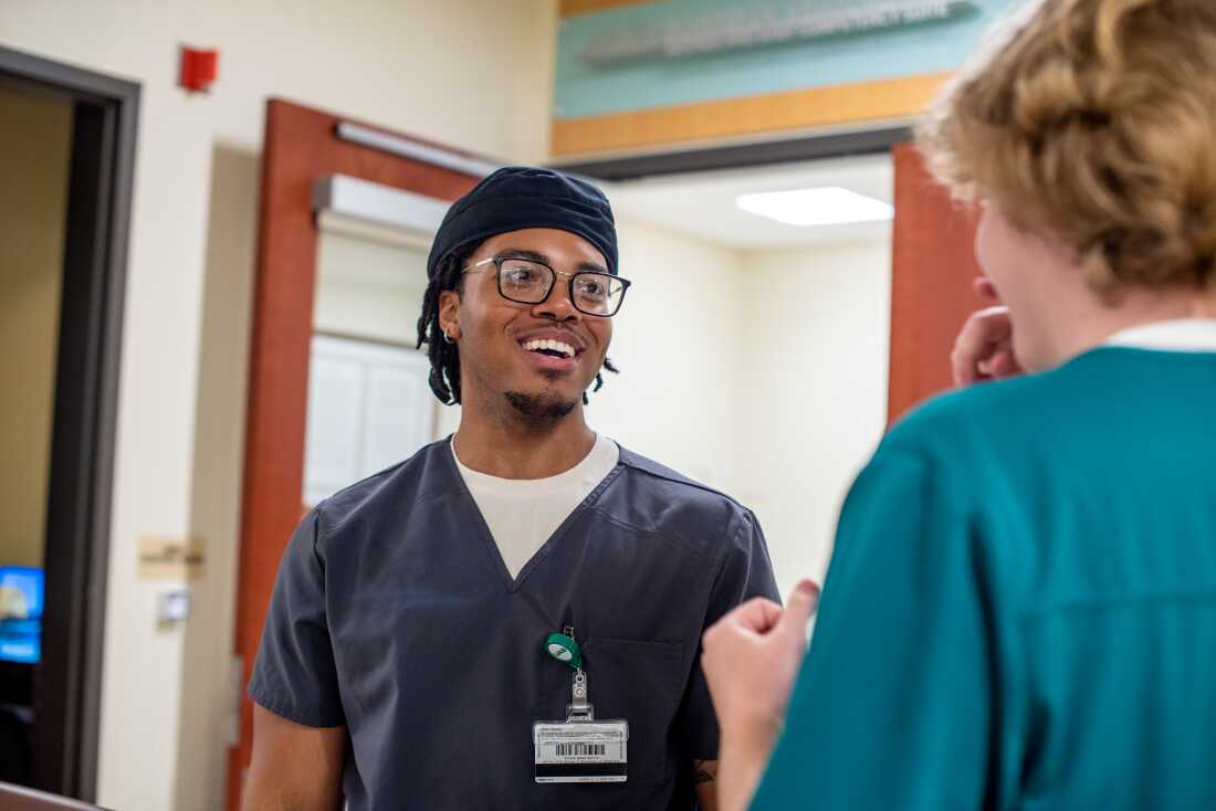 Nursing student Amiri Saadiq talks with classmate Ethan Stinson in the simulation suite.