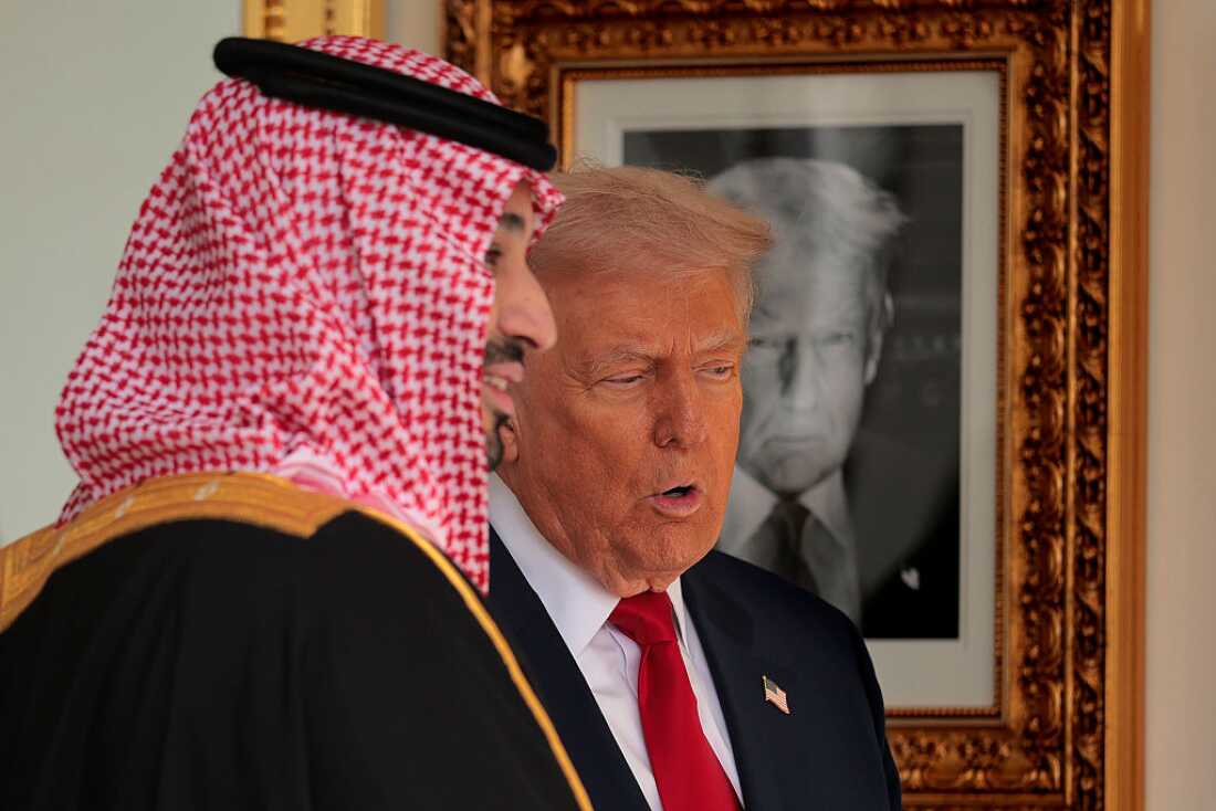 With a photograph of himself on the wall as part of "The Presidential Hall of Fame," U.S. President Donald Trump (R) gives Crown Prince and Prime Minister Mohammed bin Salman of Saudi Arabia a tour of the White House on November 18, 2025 in Washington, DC.