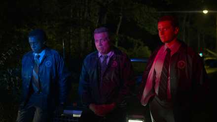 Bill and Holden bathed in colored police lights in Mindhunter