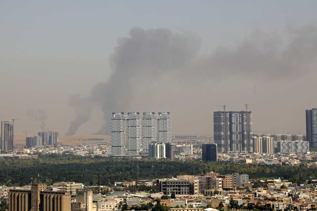 Smoke rises after explosions were heard and air defences activated near the airport in Erbil, on July 24, 2026. Several blasts sounded on July 24 near Erbil airport, which hosts US-led coalition troops in Iraq's autonomous Kurdistan region, an AFP journalist said.