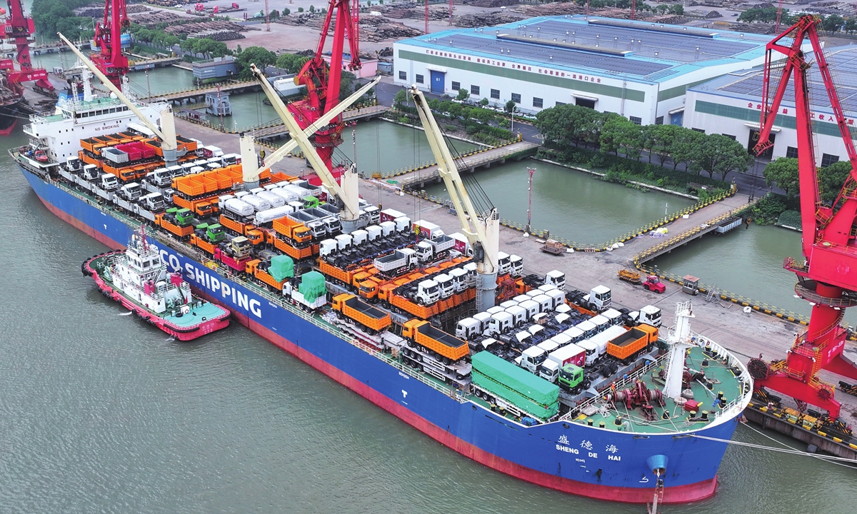 A cargo vessel carrying engineering vehicles for export is seen at a port in Zhangjiagang, East China's Jiangsu Province, on July 21, 2026. Photo: VCG