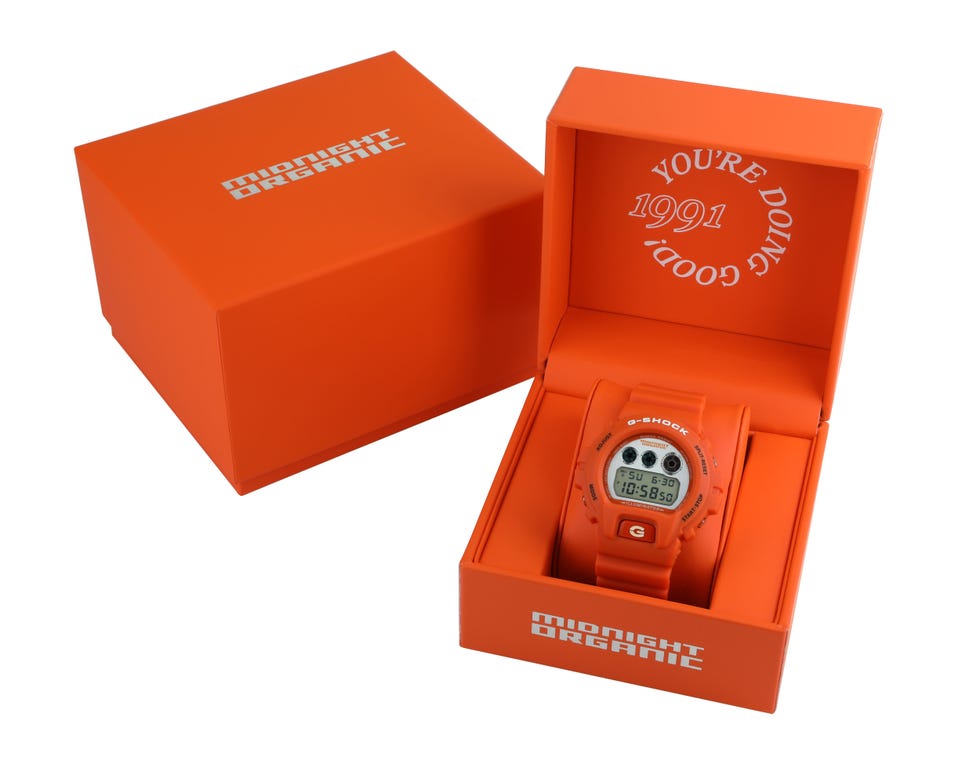 orange g shock watch in midnight organic branded packaging. orange g shock watch in midnight organic branded packaging.