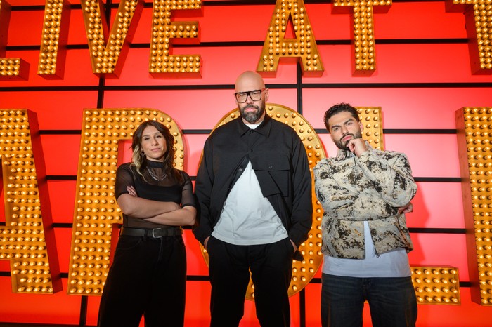 Louise Young, Tom Davis and Kae Kurd stood next to each other in front of the Live at the Apollo logo.