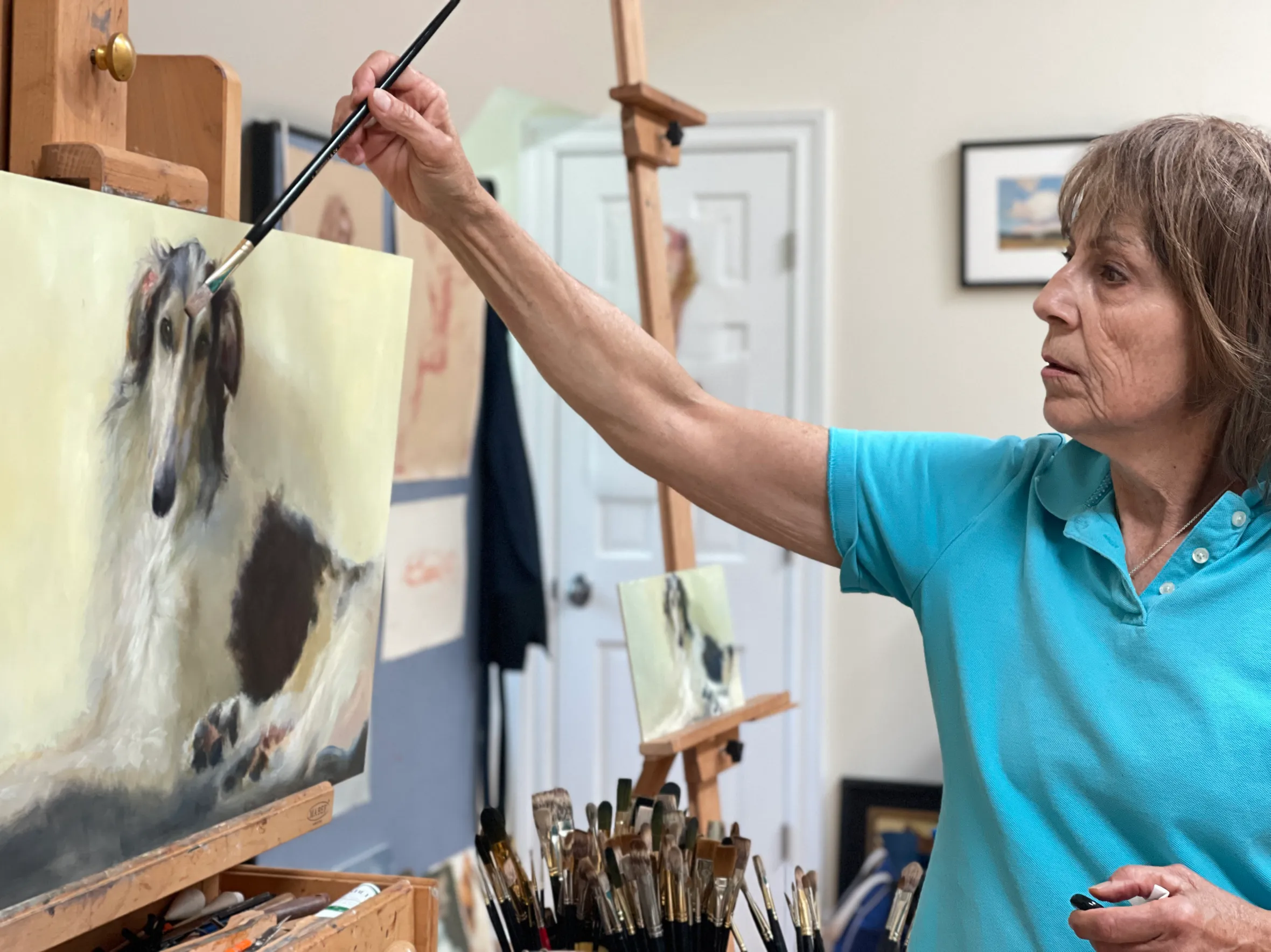 Johanne Mangi painting a portrait of a dog.