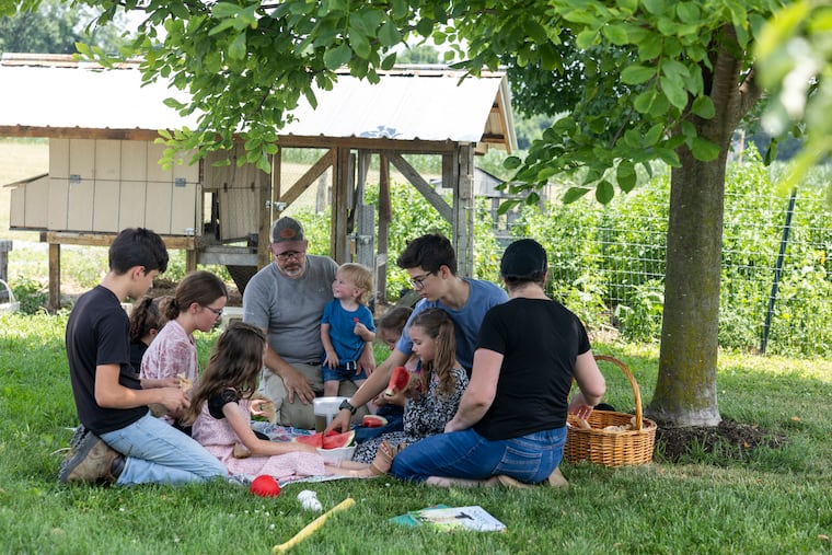 Shawn and Gina King eat lunch outside with their eight children at their home outside New Holland after recovering from measles.