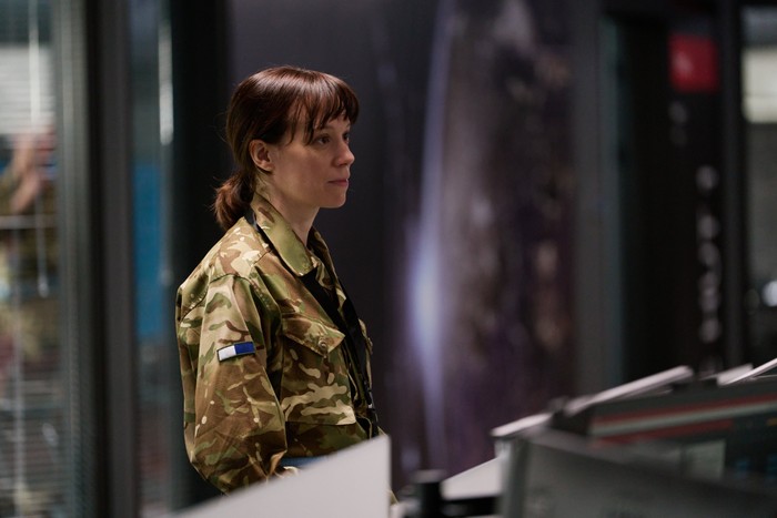 The Undeclared War - Series 2 Ep1 Chloe Pirrie as Lt Col Roz Cavendish in The Undeclared War, wearing an army uniform and stood in an office.