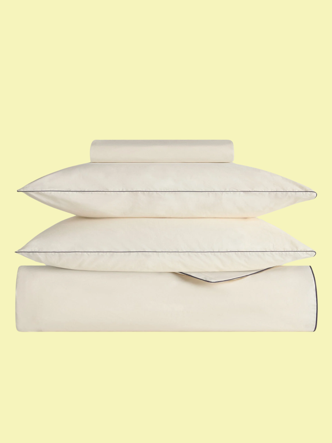 A crisp and cool bedding set from Rise &amp; Fall in buttermilk with navy piping