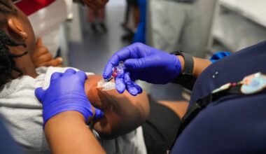Mia Williams, a registered nurse, vaccinates a 9-year-old girl inside Delaware County Health Department's Wellness on Wheels mobile clinic in Upper Darby.