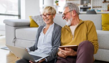 Happy senior couple hugging and enjoying retirement at home