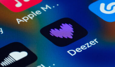 Close-up view of a smartphone screen displaying popular music streaming and audio applications, highlighting Deezer
