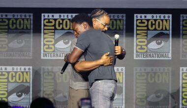 Ryan Coogler hugs David Jonsson on stage during Marvel's Comic-Con panel.