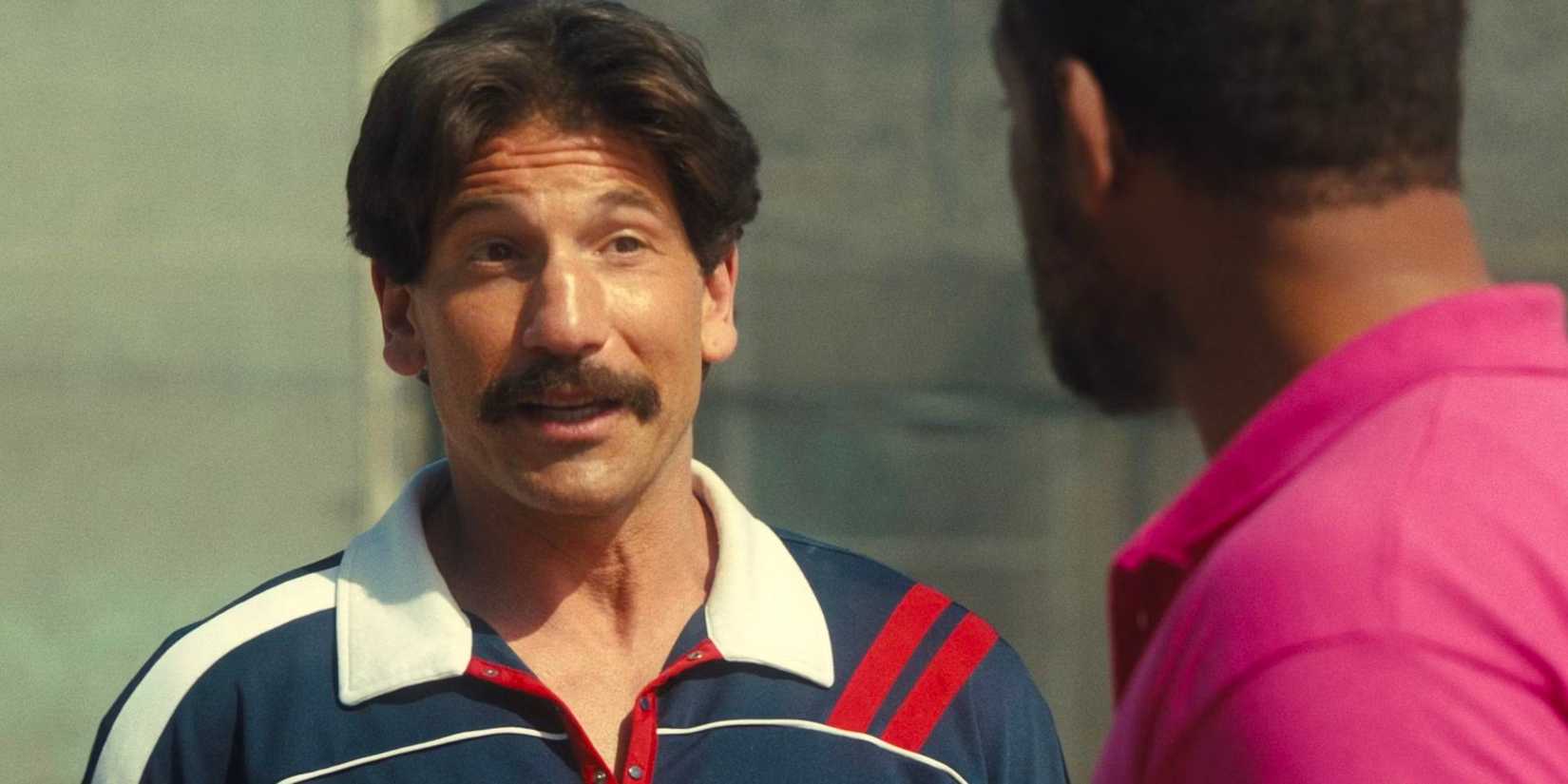 Jon Bernthal in retro clothes talks to Will Smith in 'King Richard'.