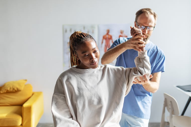 A patient works with a physical therapist. NovaCare Rehabilitation, not shown in the photo, operates physical therapy locations nationally and in the Philadelphia area. It is being sold as part of a private-equity-backed transaction that includes management.