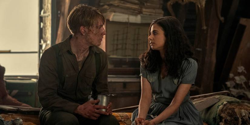 Louis Hofmann and Aria Mia Loberti sitting next to each other in 'All the Light We Cannot See'