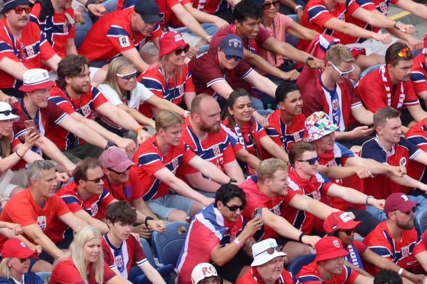 Emil Lappen, center, refuses to take part as Norwegian fans perform a viking boat row against France in Foxborough, Mass., near Boston, on Friday, June 26.
