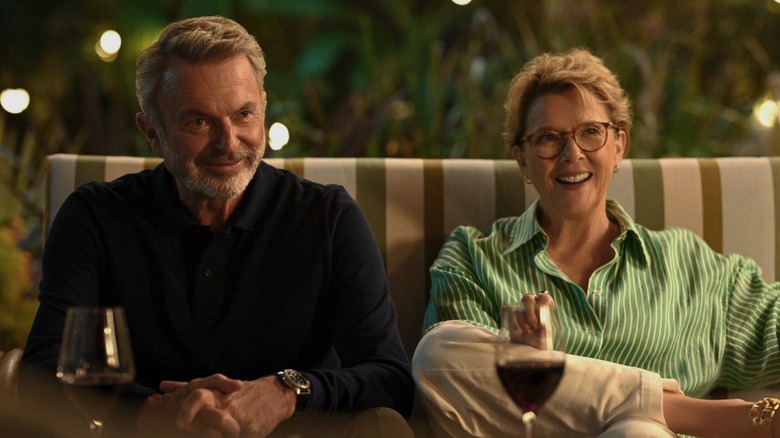 Sam Neill as Stan Delaney and Joy Delaney as Annette Bening sitting on a couch in Apples Never Fall