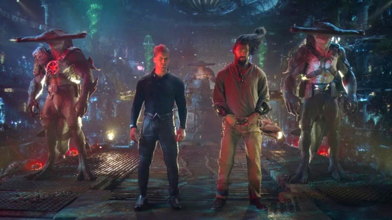 Aquaman (Jason Momoa) and Orm (Patrick Wilson) apprehended by sharks in Aquaman and the Lost Kingdom