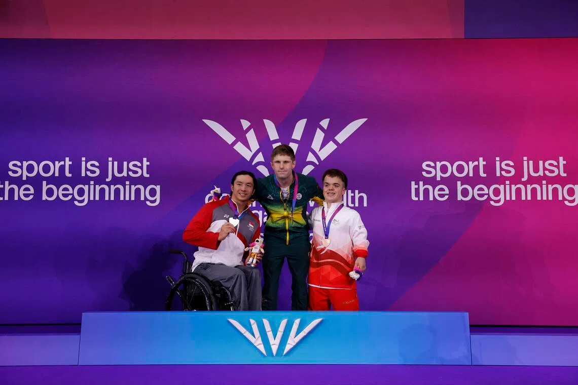 Singapore’s Toh Wei Soong celebrating his 50m freestyle S7 silver medal with winner Christian Sadie of South Africa and England’s bronze medallist Bruce Dee on the podium at the Tollcross International Swimming Centre in Glasgow on July 29.