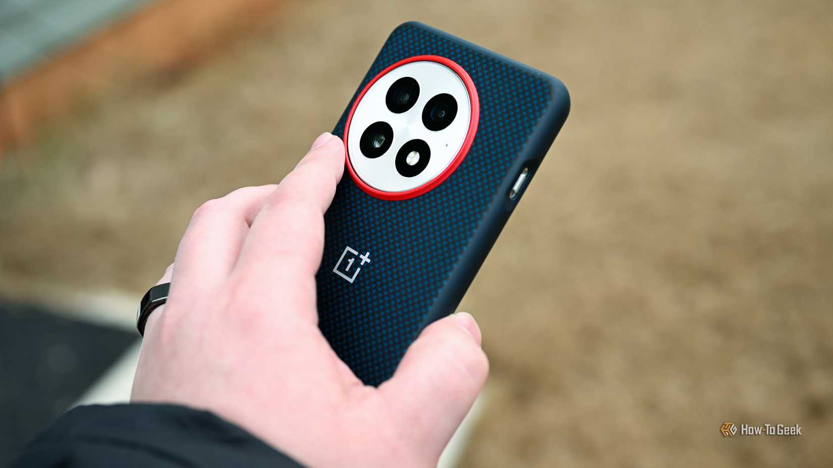 Back side of the OnePlus 13 inside a phone case.