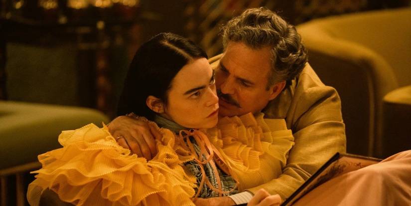 Mark Ruffalo as Duncan hugging an annoyed Emma Stone as Bella in Poor Things.