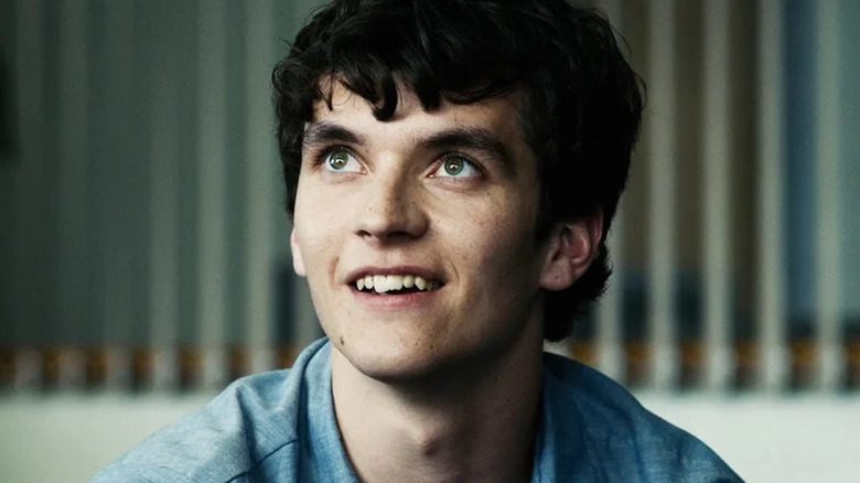 Fionn Whitehead's Stefan Butler smiling and looking up on Black Mirror: Bandersnatch