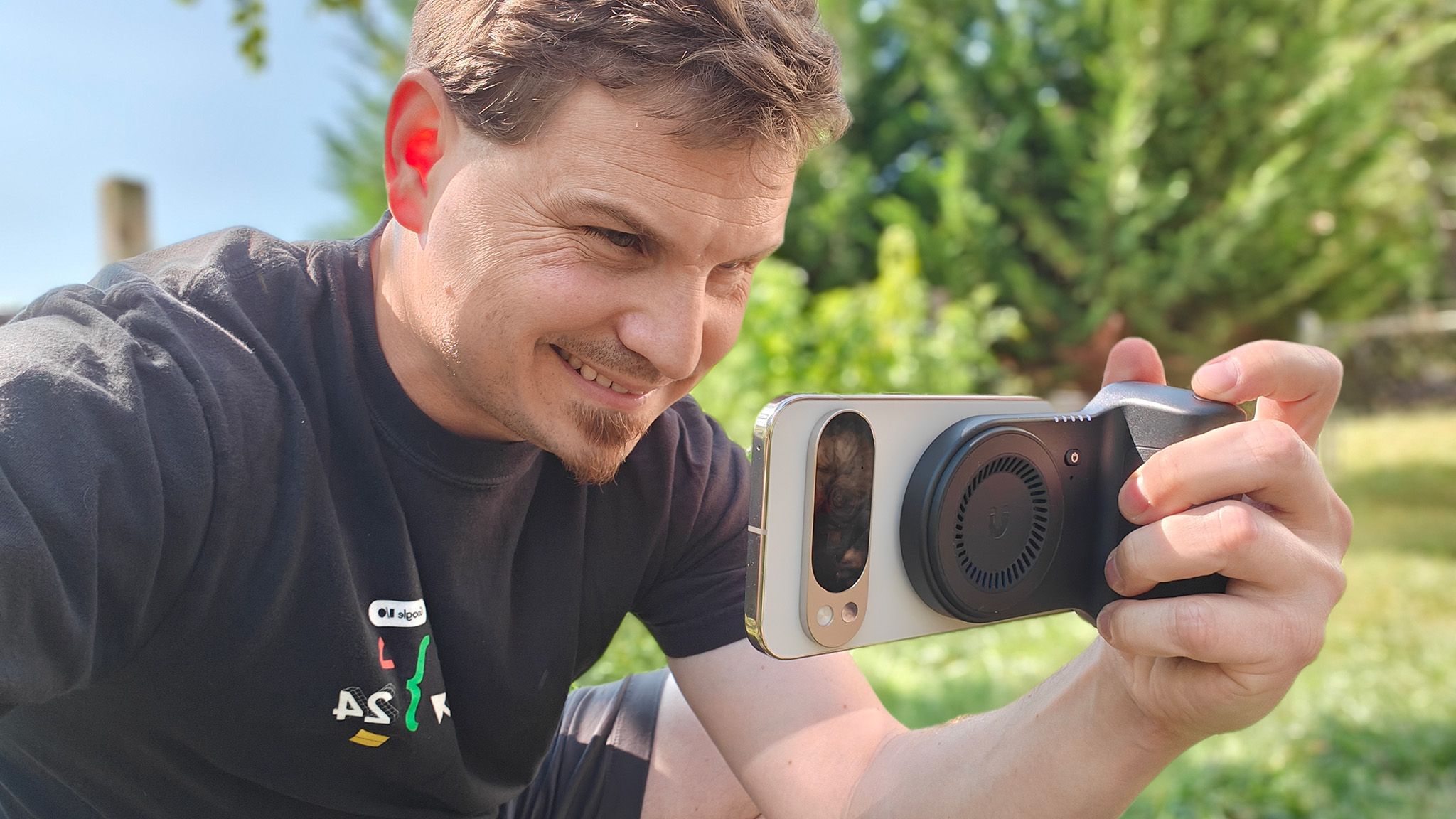 Using a KraftGeek magnetic camera grip attached to a Google Pixel 10 Pro XL to take a photo