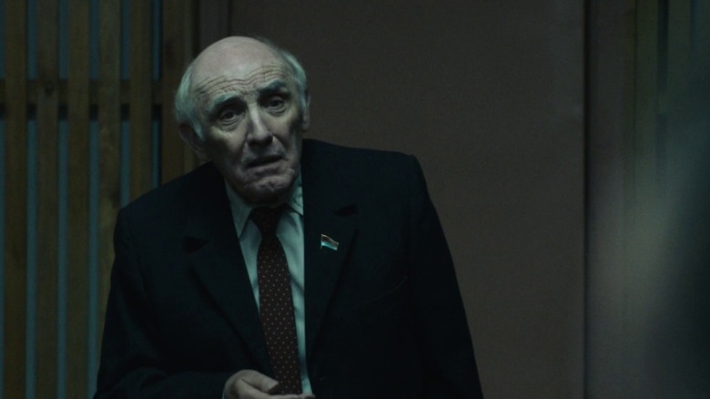 Zharkov standing and gazing out with his brow furrowed on Chernobyl S1E1