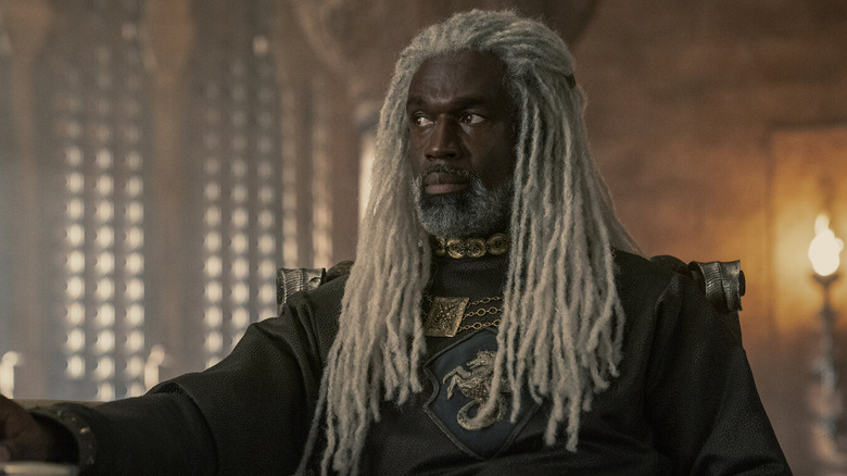 Steve Toussaint as Corlys Velaryon sitting and looking off to the side in House of the Dragon
