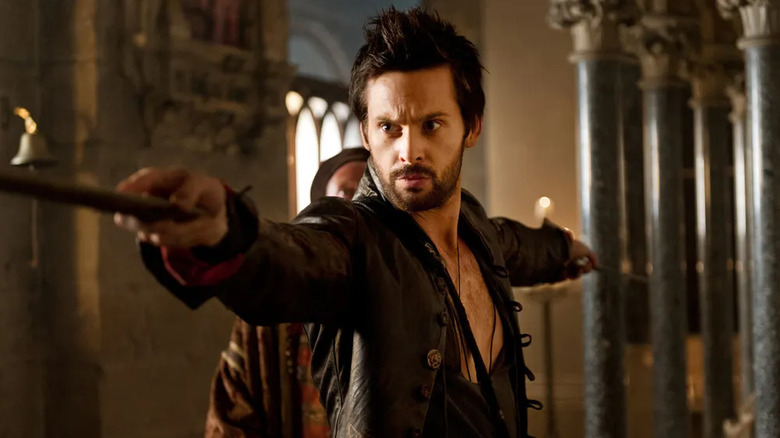 Leonard Da Vinci holding a wand
