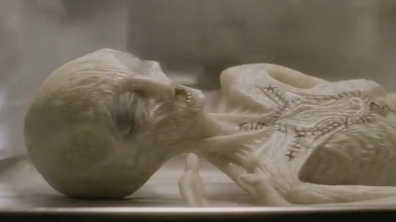 An alien lying on a table on 