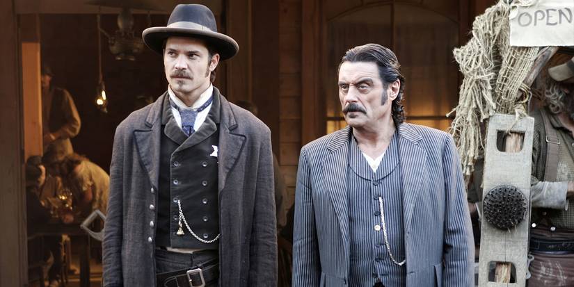 Seth Bullock (Timothy Olyphant) and Al Swearengen (Ian McShane) stand outside a building in Deadwood.