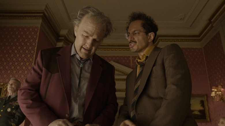 Tom Cruise as Digger Rockwell standing next to Riz Ahmed's character in Digger