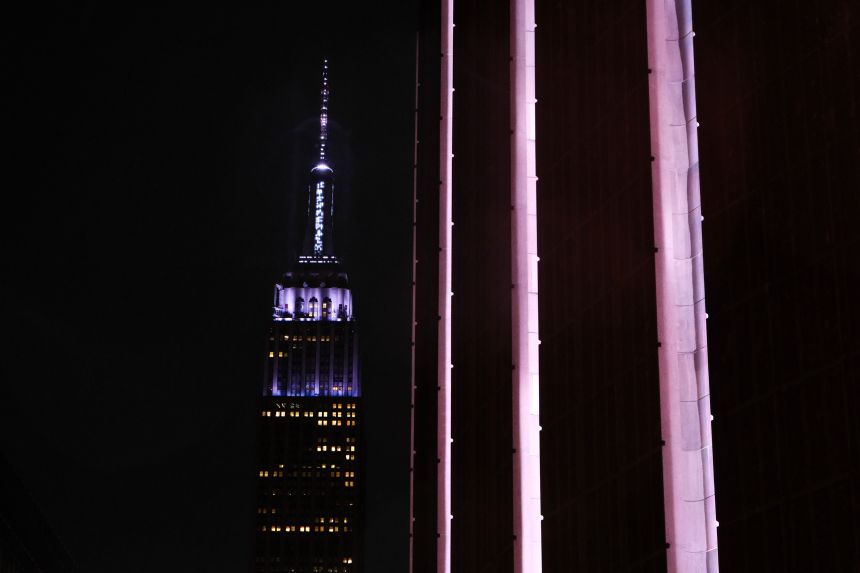 The Empire State Building is seen illuminated behind Madison Square Garden in New York on Friday.