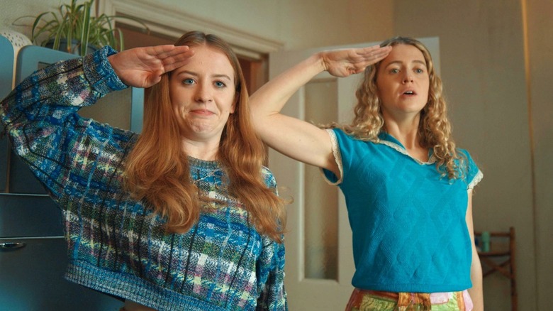 Máireád Tyers and Sofia Oxenham as Jen and Carrie saluting in Extraordinary