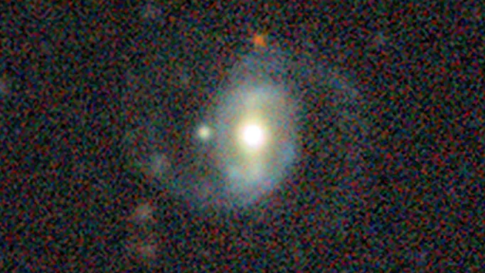A blurry image of a blue blob on a black background.