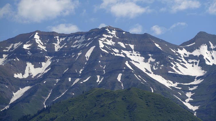 Snow partially covers mountains