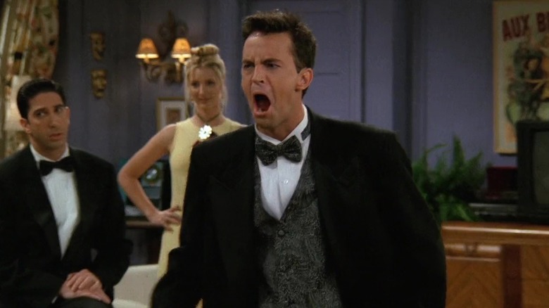 Ross (David Schwimmer) and Phoebe (Lisa Kudrow) watch Chandler (Matthew Perry) yell in Friends