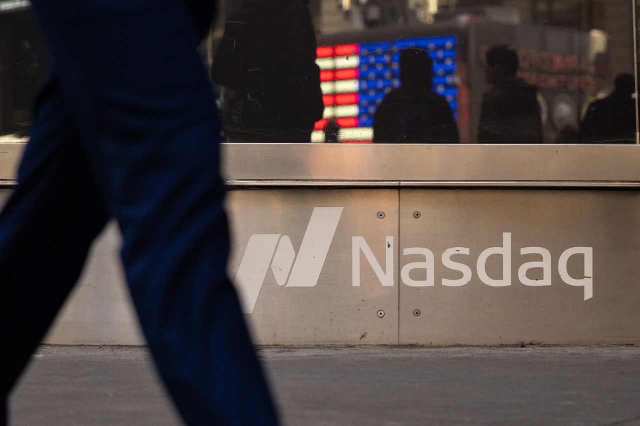 A person walks past Nasdaq headquarters in Times Square in New York City on January 30, 2025.