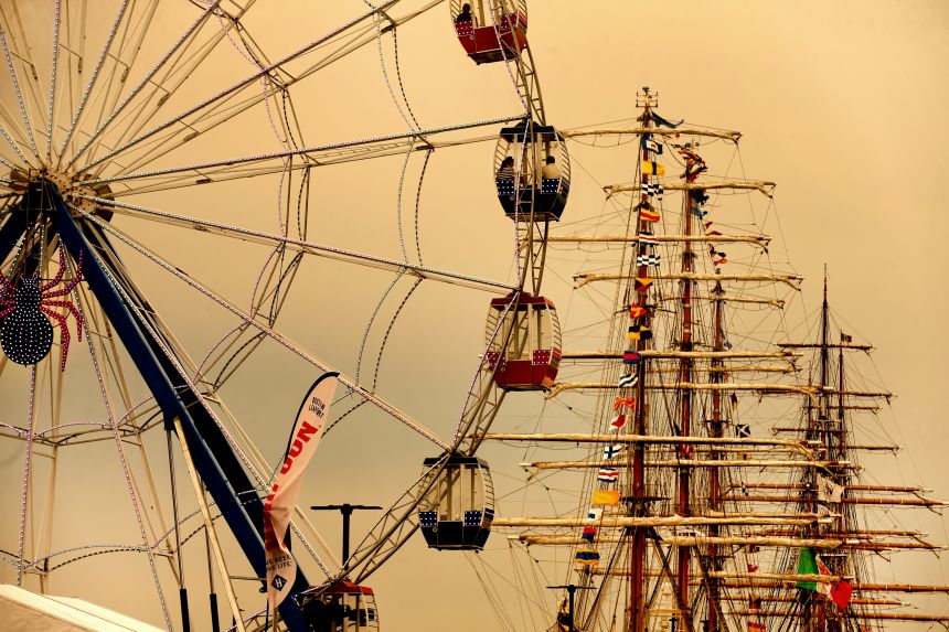 A yellowish sky from Canadian wildfires forms the backdrop for a Ferris wheel that spins at Pier 5 in the Boston Seaport on July 14, 2026.