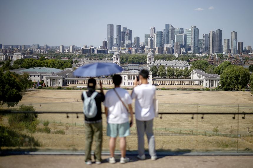 People shelter from the sun as the nation endures record-high temperatures.