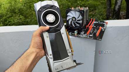 A person holding a GTX 1080 Founders Edition GPU in front of a server PC