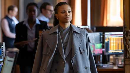 Myha'la walking into the office wearing a coat in Industry Season 4