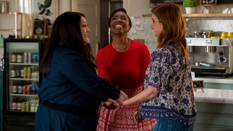 Dana Sue Sullivan (Brooke Elliott), Helen Decatur (Heather Headley), and Maddie Townsend (JoAnna Garcia Swisher) happily hold hands in Sweet Magnolias