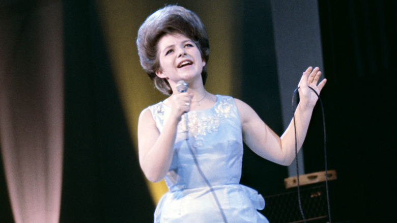 Brenda Lee singing in stage in blue dress