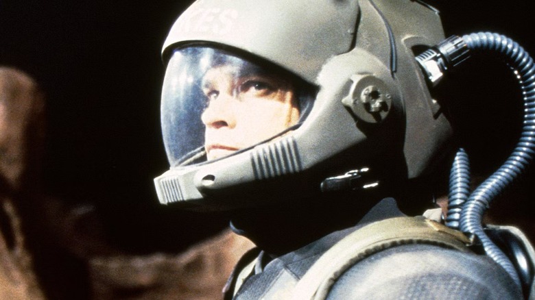 Nathan (Morgan Weisser) wearing a space suit on 